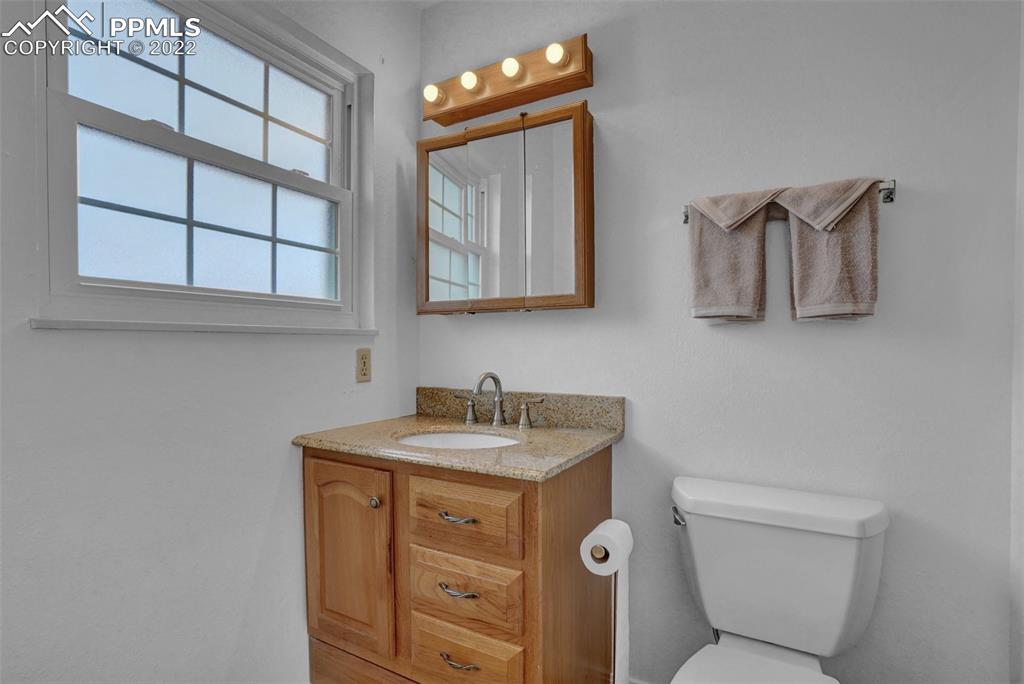 4930 Harvest Road Colorado Springs, CO 80917 - Photo 33 of 39 a bathroom with a toilet sink and mirror