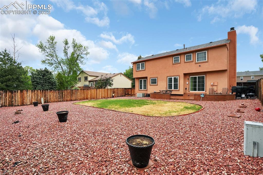 4930 Harvest Road Colorado Springs, CO 80917 - Photo 37 of 39 a view of a house with a swimming pool and sitting area