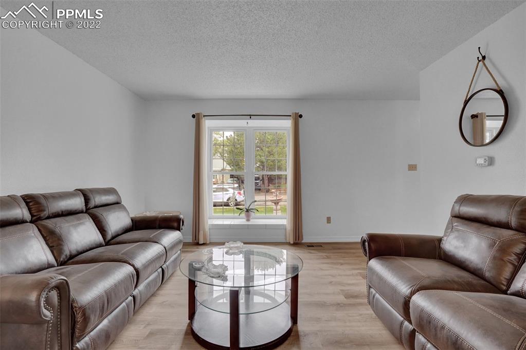 4930 Harvest Road Colorado Springs, CO 80917 - Photo 6 of 39 a living room with furniture and a window
