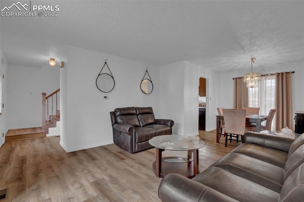 4930 Harvest Road Colorado Springs, CO 80917 - Photo 8 of 39 a living room with furniture and wooden floor