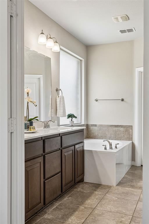 2508 Red Draw Road Fort Worth, TX 76177 - Photo 21 of 38 Spa-inspired primary bathroom featuring a dark wood vanity with dual sinks, white quartz countertop, and polished nickel fixtures