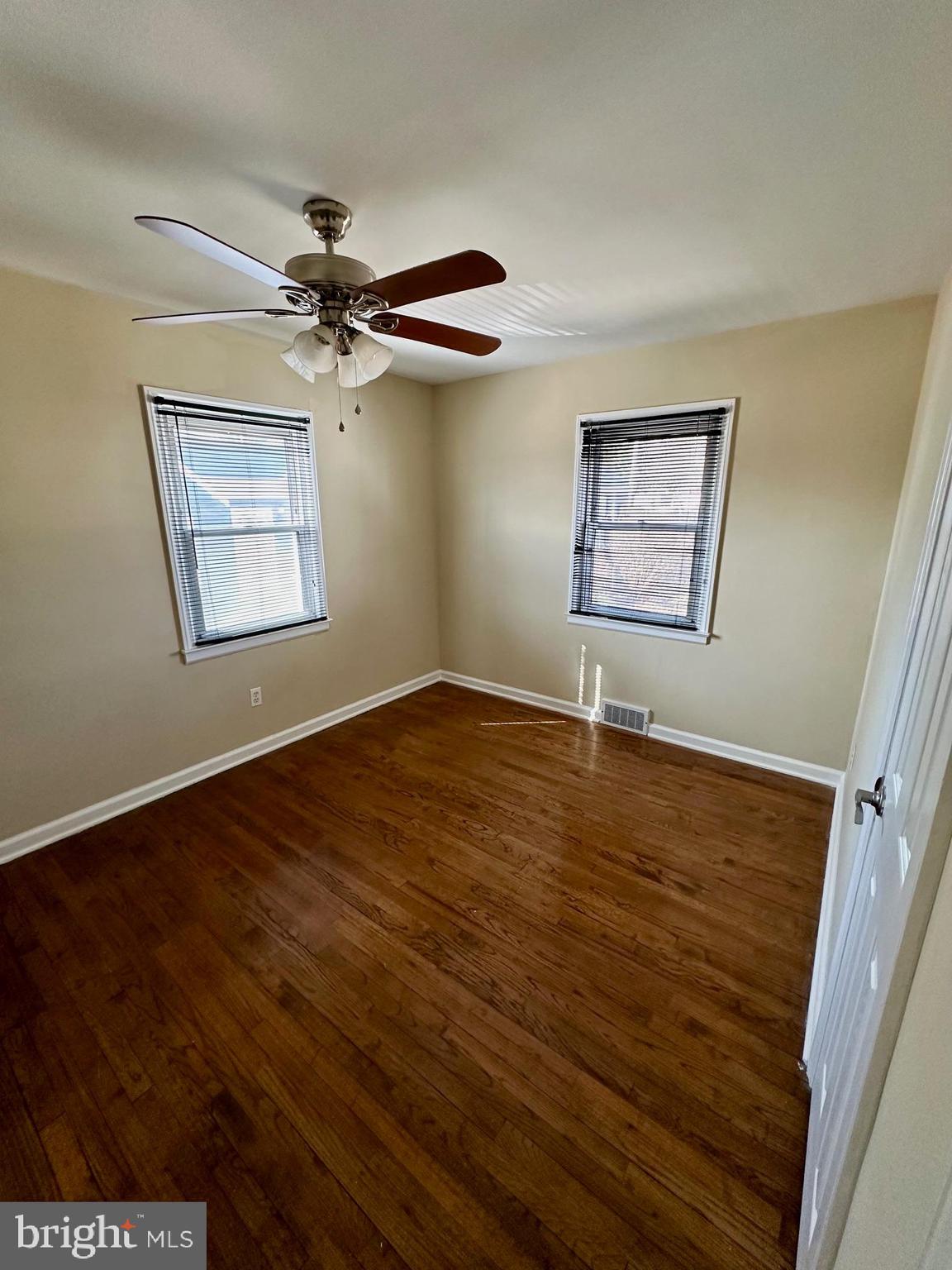 128 Central Avenue Ewing, NJ 08628 - Photo 9 of 15 a view of an empty room with a window and wooden floor