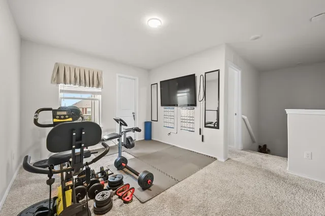 a bedroom with furniture and a flat screen tv