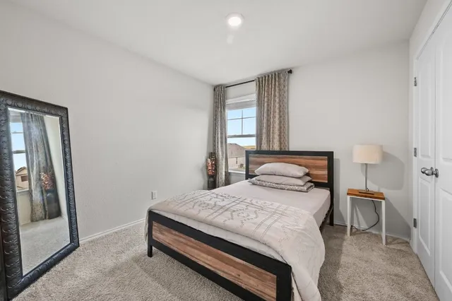 a bedroom with a bed and a window