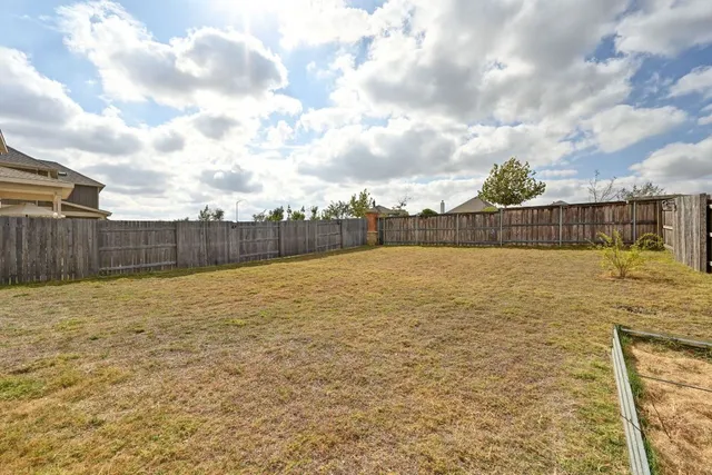 a building outdoor space with patio furniture and potted plants