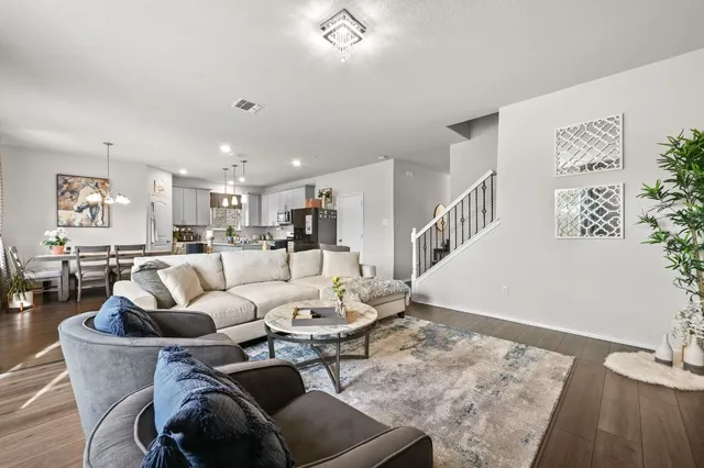 a living room with furniture kitchen view and a table