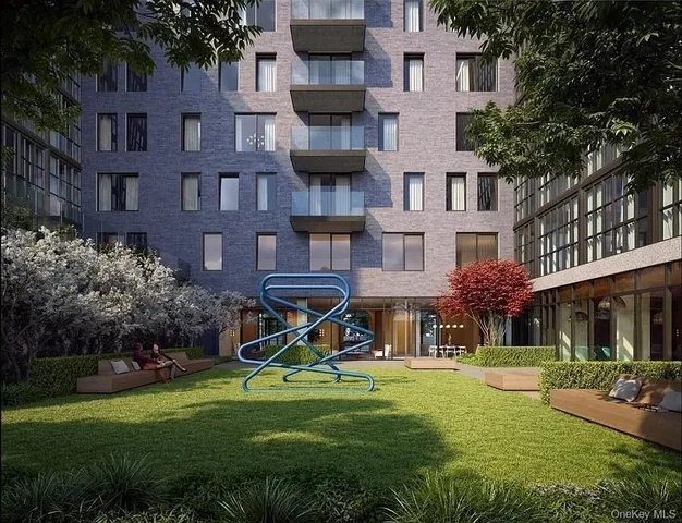 a view of a brick house with a yard and potted plants