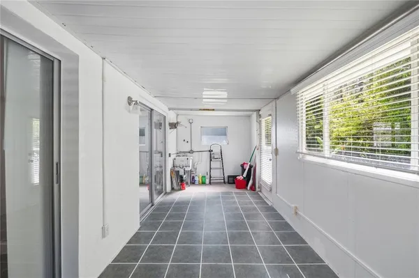 a view of empty room with wooden floor and windows