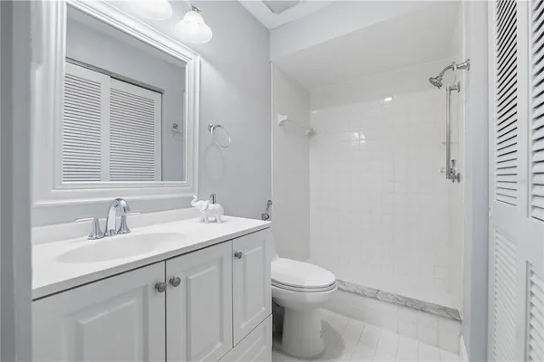 a bathroom with a sink a toilet a mirror and vanity