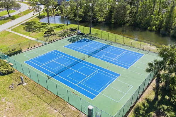 a view of a tennis court with a large pool