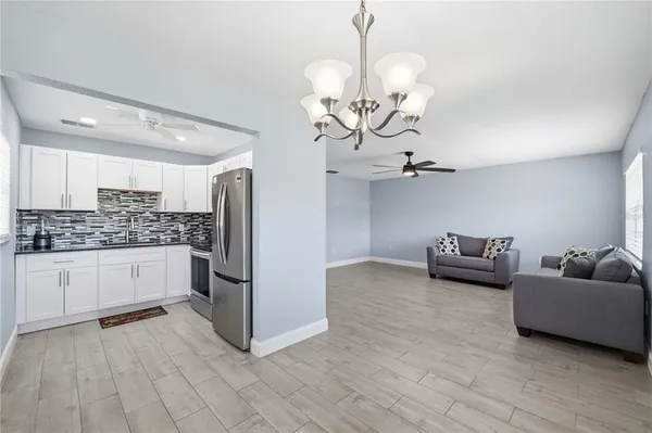 a kitchen with stainless steel appliances granite countertop a refrigerator and a sink