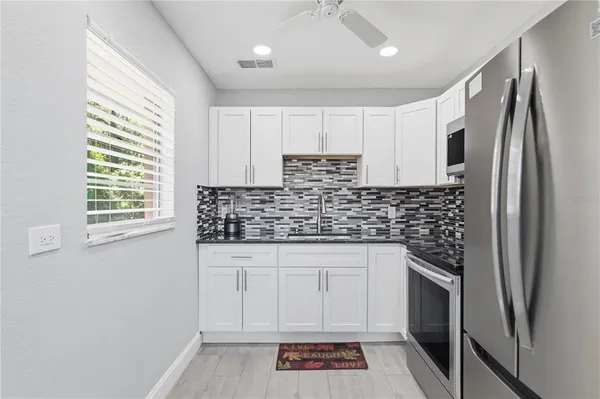 a kitchen with stainless steel appliances a refrigerator sink and cabinets