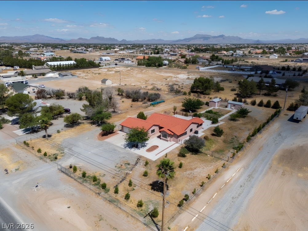 1220 East Gamebird Road Pahrump, NV 89048 - Photo 44 of 49 An aerial perspective reveals a spacious property set against a scenic mountain backdrop.
