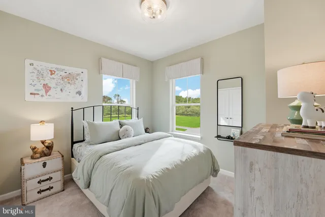 a bedroom with a bed and painting on the wall