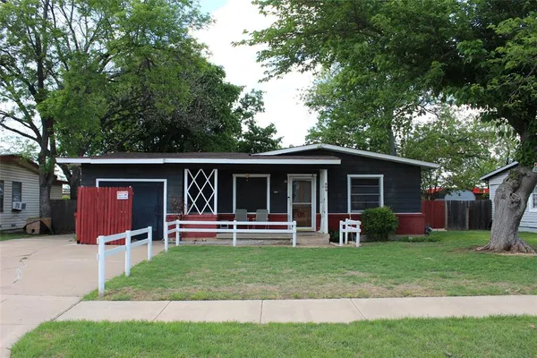a front view of house with yard and outdoor seating