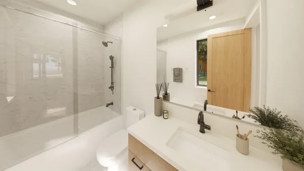 a bathroom with a tub sink and mirror