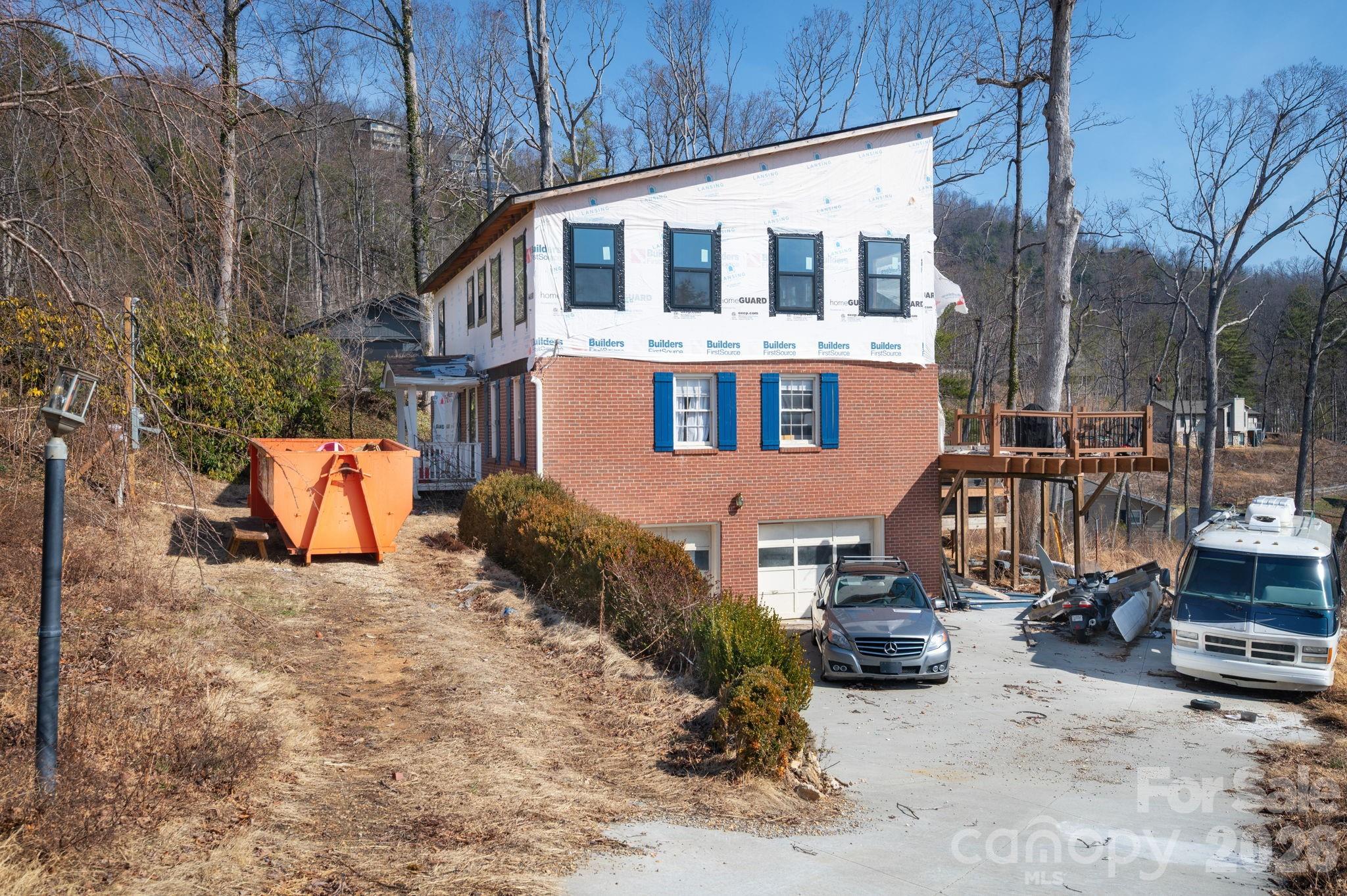59 Faircrest Road Asheville, NC 28804 - Photo 6 of 24 a view of a blue house with a yard covered in snow