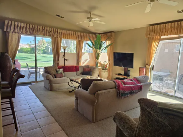 a living room with furniture or outdoor view and a large window