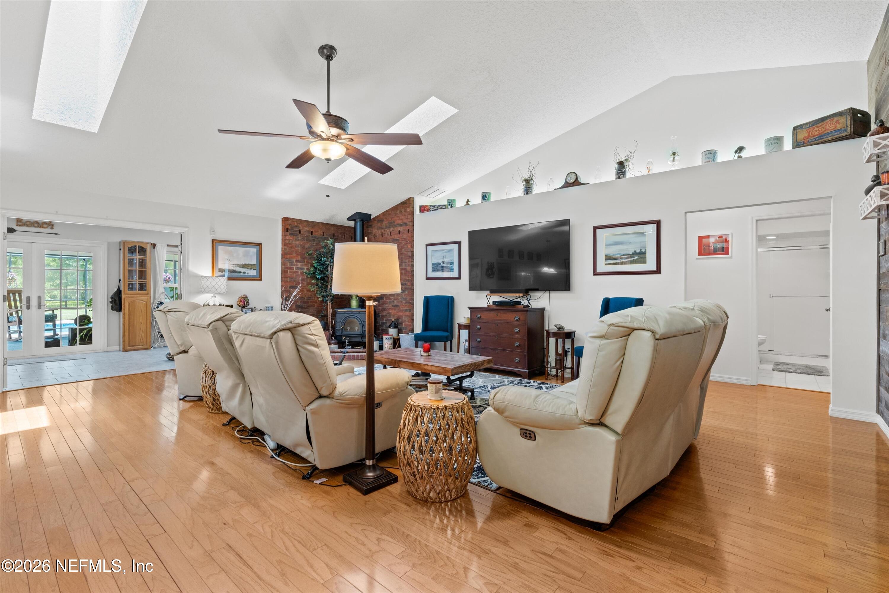 5566 Don Manuel Road Elkton, FL 32033 - Photo 9 of 47 a living room with furniture a fireplace and a flat screen tv