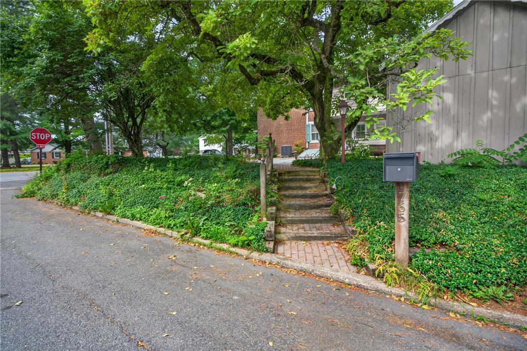 765 East Macada Road Bethlehem, PA 18017 - Photo 4 of 46 A charming brick pathway guides to a private, tree-shaded residence from the street.