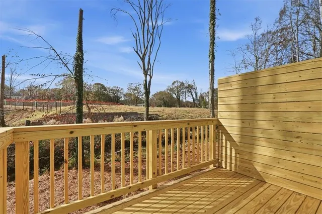 a view of a balcony with wooden floor and fence