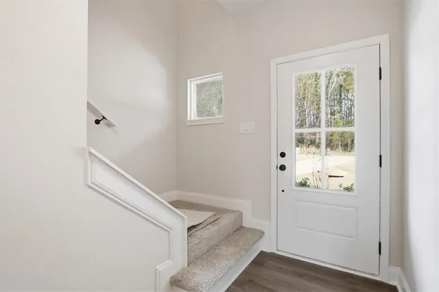 a view of entryway with wooden floor and cabinet