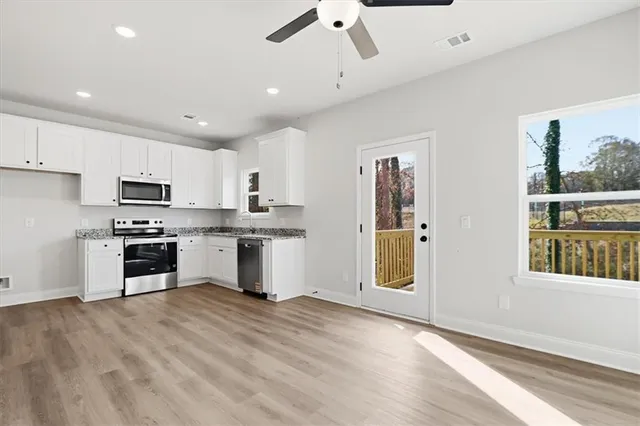 a kitchen with a refrigerator and a stove top oven