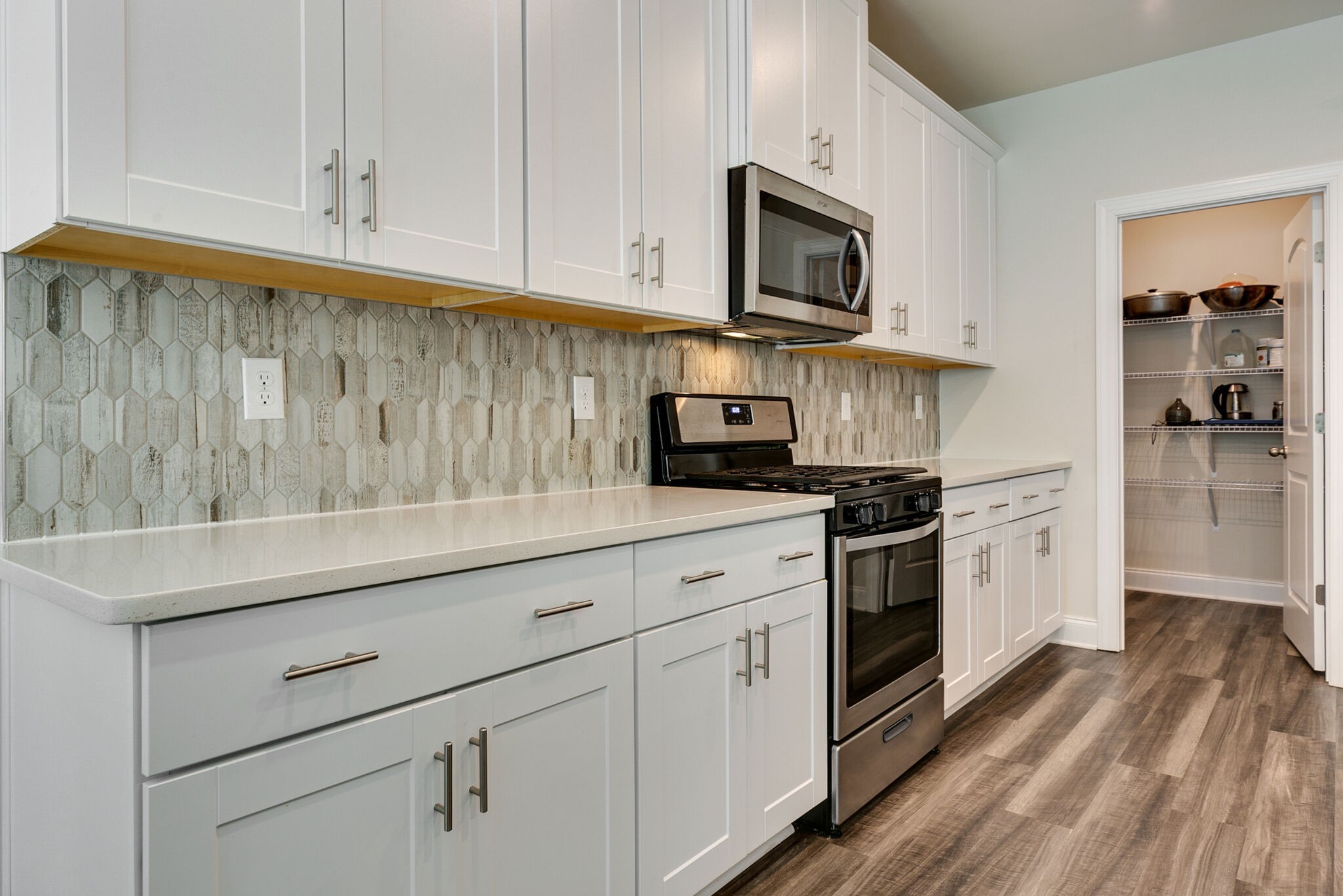 3264 Longstalk Road Antioch, TN 37013 - Photo 12 of 49 a kitchen with stainless steel appliances granite countertop a sink a stove and a microwave