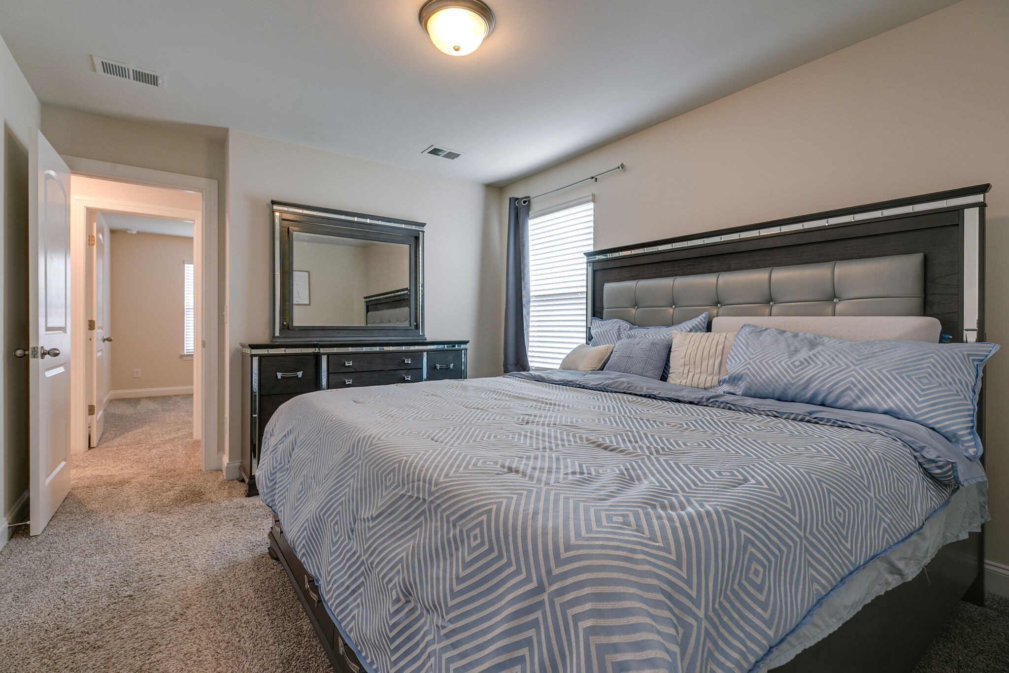 3264 Longstalk Road Antioch, TN 37013 - Photo 20 of 49 a bedroom with a bed and a chandelier