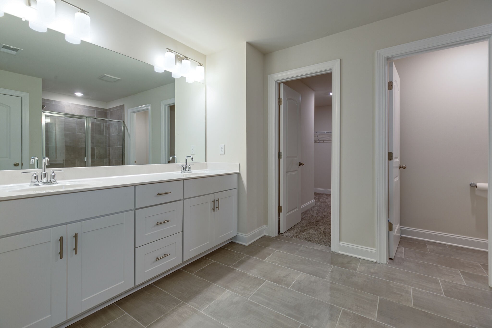3264 Longstalk Road Antioch, TN 37013 - Photo 30 of 49 a spacious bathroom with a double vanity sink a mirror and a shower