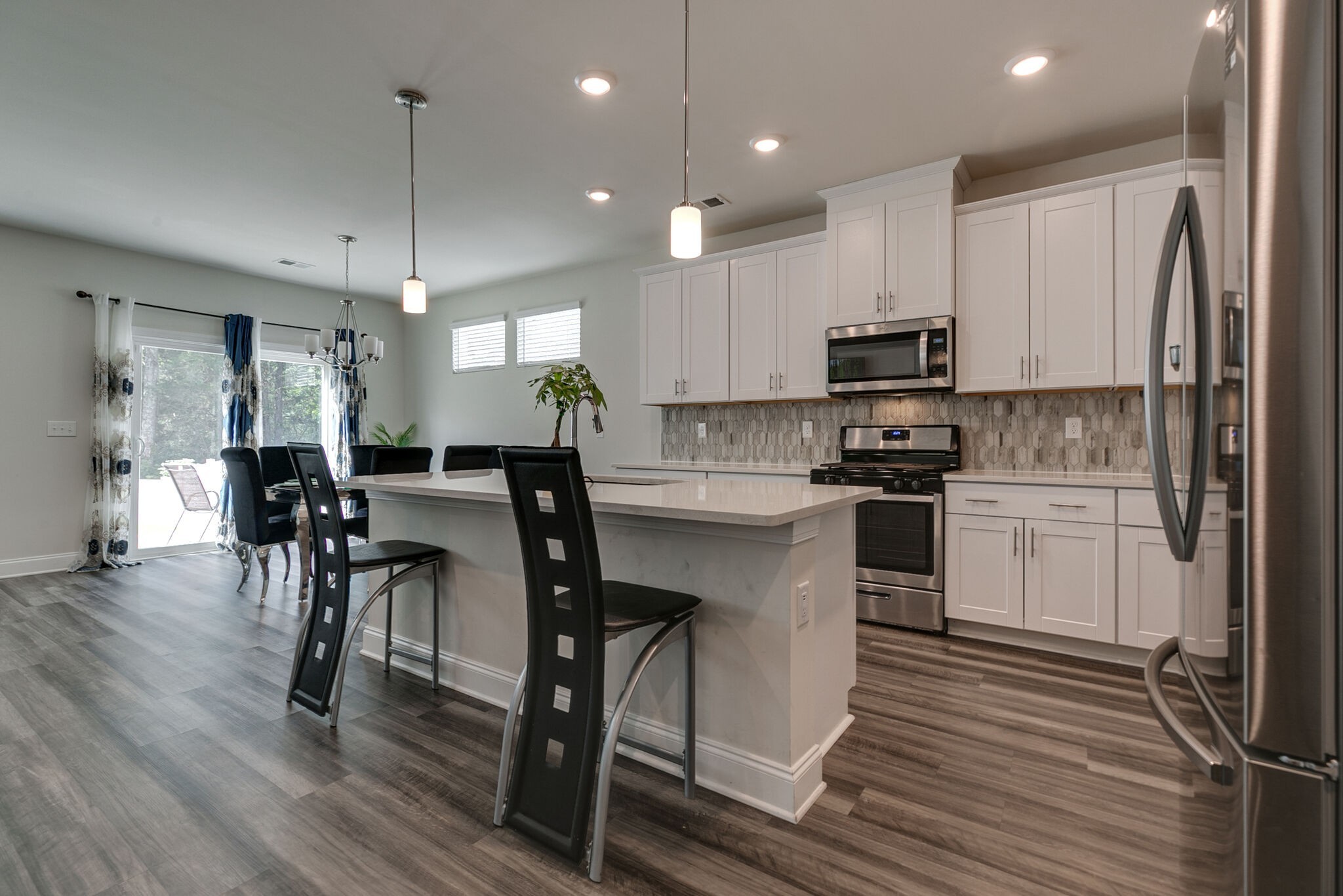 3264 Longstalk Road Antioch, TN 37013 - Photo 9 of 49 a kitchen with a table chairs refrigerator and microwave