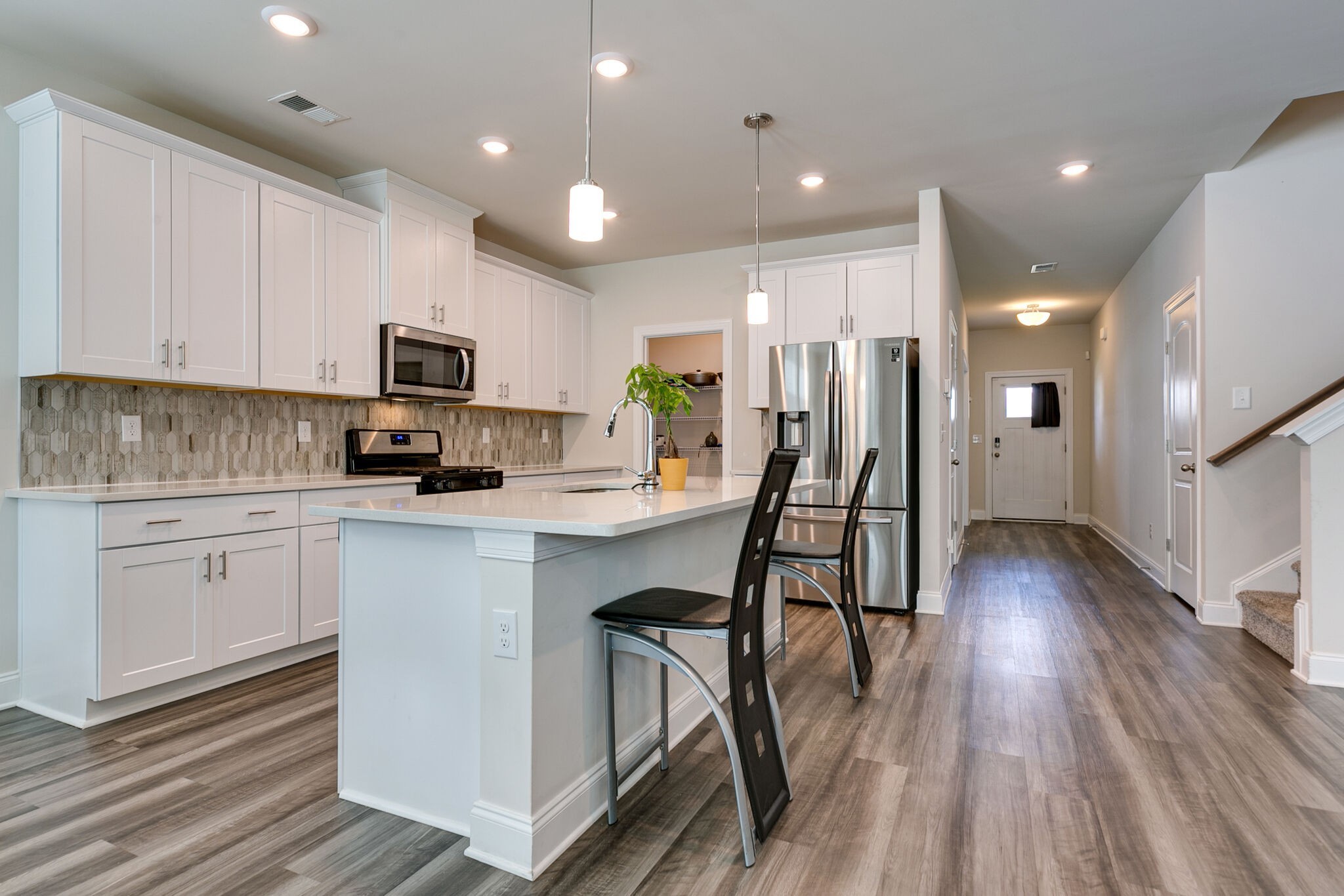 3264 Longstalk Road Antioch, TN 37013 - Photo 10 of 49 a kitchen with stainless steel appliances granite countertop a refrigerator a stove top oven a sink dishwasher and white cabinets with wooden floor