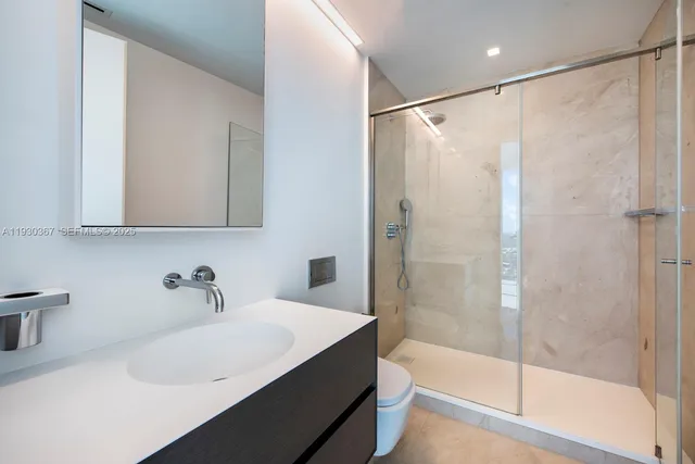 a spacious bedroom with a large window and a balcony