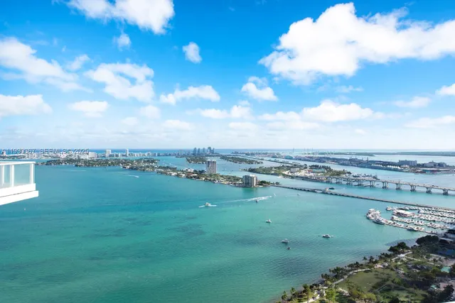 a bed sitting in a bedroom next to a large window