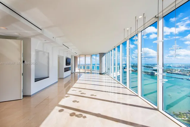 a view of a hallway with a large window and a rug