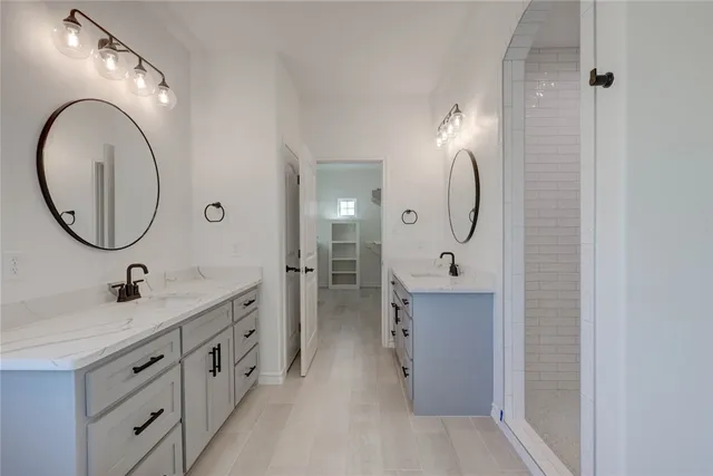a bathroom with a sink double vanity and a mirror