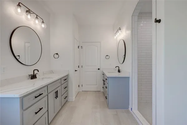 a bathroom with a sink double vanity and a mirror
