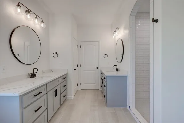 a bathroom with a sink double vanity and a mirror