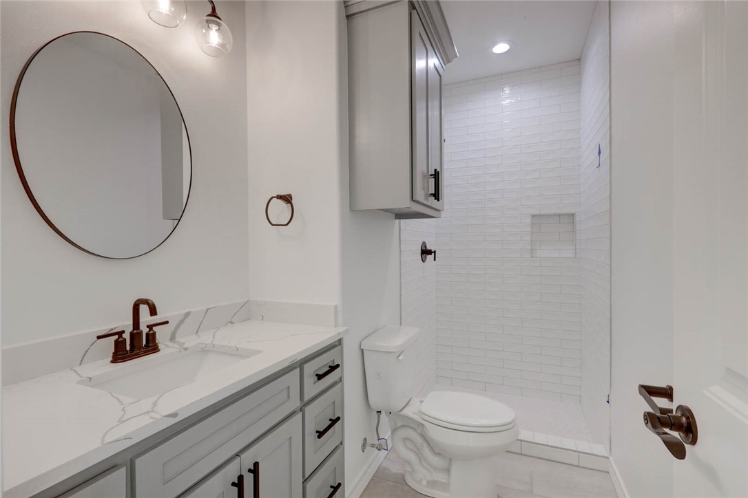 141 Amethyst Street Portland, TX 78374 - Photo 21 of 22 a bathroom with a sink a toilet and a mirror