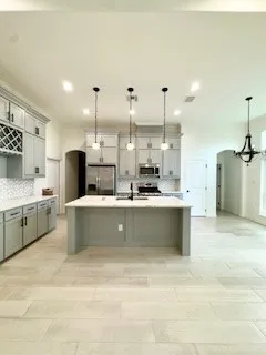 a large kitchen with a large counter top appliances and cabinets