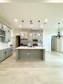 141 Amethyst Street Portland, TX 78374 - Photo 5 of 22 a large kitchen with a large counter top appliances and cabinets