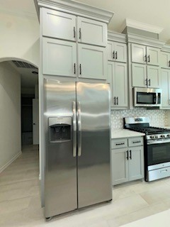 141 Amethyst Street Portland, TX 78374 - Photo 6 of 22 a metallic refrigerator freezer and a stove sitting inside of a kitchen