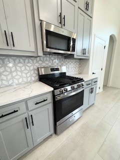 141 Amethyst Street Portland, TX 78374 - Photo 7 of 22 a kitchen with stainless steel appliances white cabinets and a stove top oven