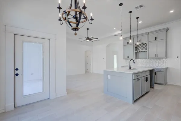 a spacious bathroom with a granite countertop sink a mirror and shower