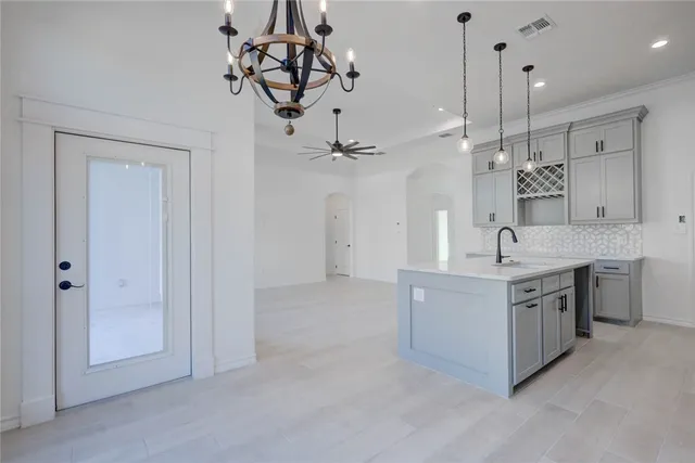a spacious bathroom with a granite countertop sink a mirror and shower