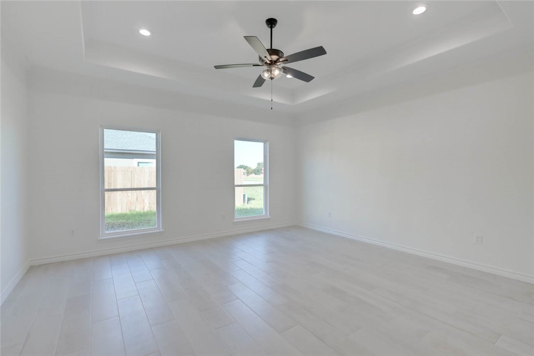 141 Amethyst Street Portland, TX 78374 - Photo 10 of 22 wooden floor in an empty room with a window