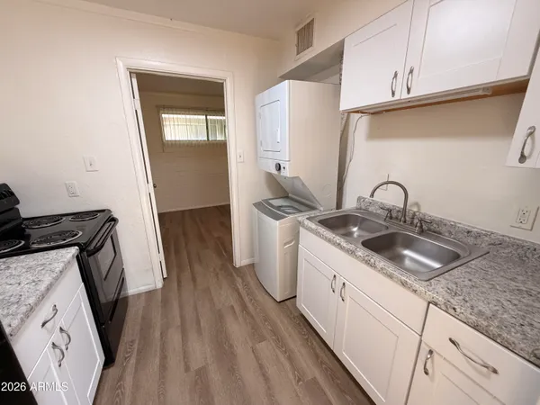 a kitchen with sink and cabinets