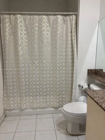 a table chair sitting in a balcony next to a yard