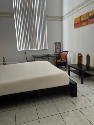 a bedroom with a bed and windows