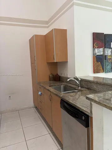 a kitchen with a sink and a refrigerator